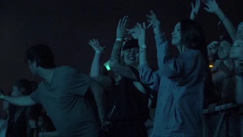Slow motion of two women dancing and a group of people having fun at a Stock Footage 107449758