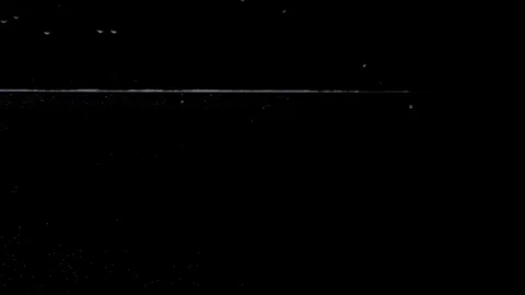 SLOW MOTION: two yellow tablets fall in water on black background Stock Footage 105299860