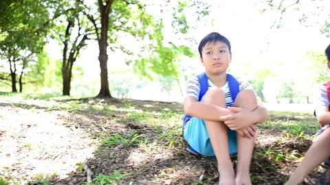 SLow motion of Two young asian boy sit in a park Stock Footage 86636625