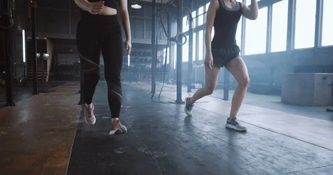 Slow motion two young beautiful athletic European women working out together Stock Footage 116882649