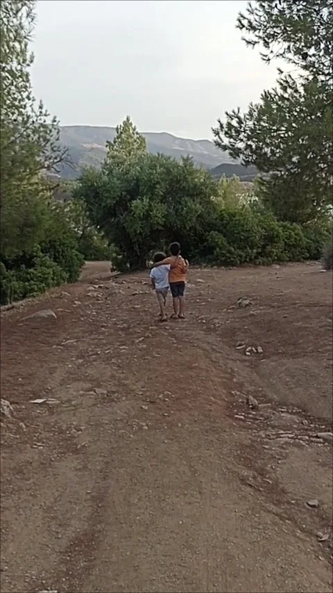 Slow Motion of Two Young Boys Exploring Forest Path 스톡 동영상 335416018