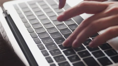 Slow motion typing text on modern silver laptop 4K footage Stock Footage 171319310