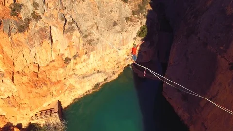 Slow motion with a unconventional athlete slacklining , highlining above a bi Stock Footage 85260697