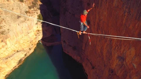 Slow motion with a unconventional man slacklining , highlining Stock Footage 85261228
