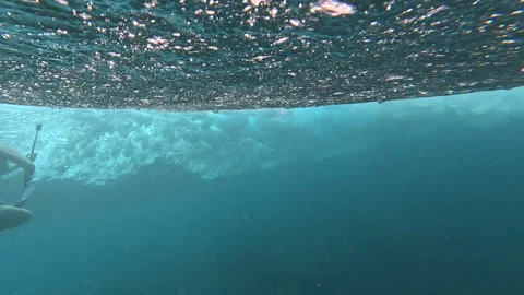SLOW MOTION, UNDERWATER: Breaking turquoise wave as a surfer glides overhead Stock Footage 339036134