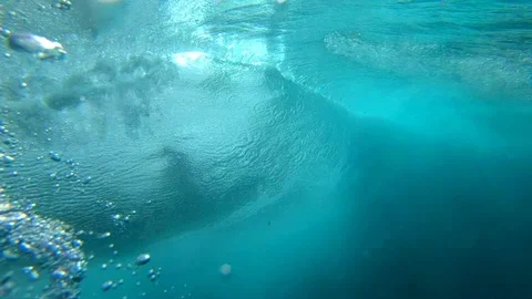 SLOW MOTION UNDERWATER: Crystal clear barrel wave breaking over camera in ocean Stock Footage