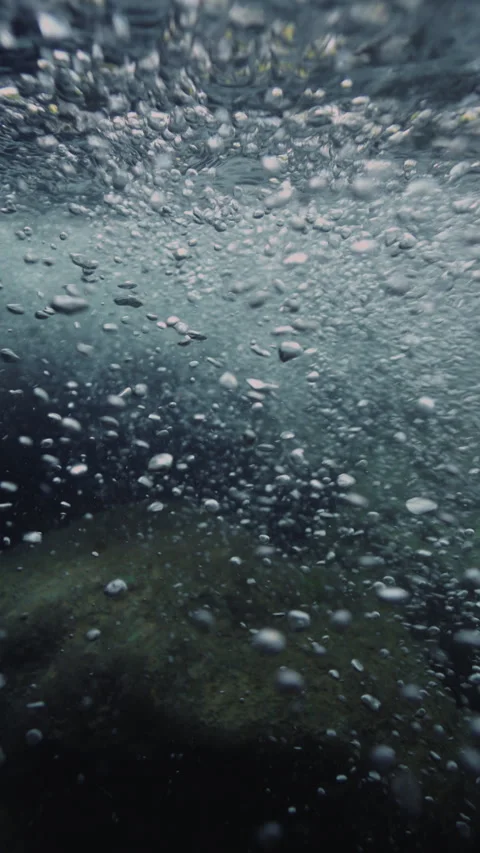Slow motion underwater sun rays hitting rocky lake floor. Stock-Footage 283648666