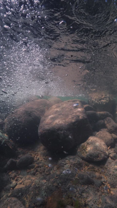 Slow motion underwater sun rays hitting rocky lake floor. Stock-Footage 283650870