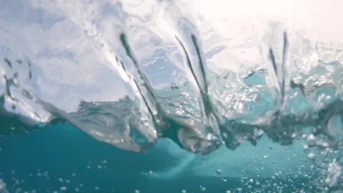 SLOW MOTION UNDERWATER Unrecognizable surfer riding big barrel wave on sunny day Stock Footage 90080834