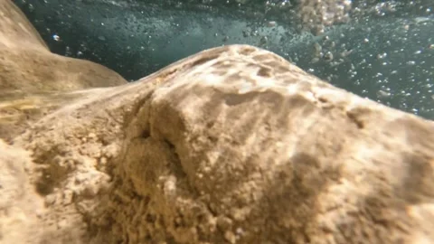 Slow motion underwater view of a clear river with sparkling sunlight Stock Footage 321860624