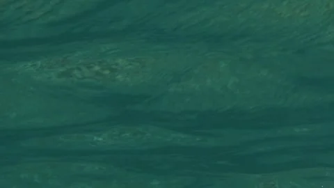 Slow motion underwater: waves rolling overhead, underneath the ocean Stock Footage 266652748