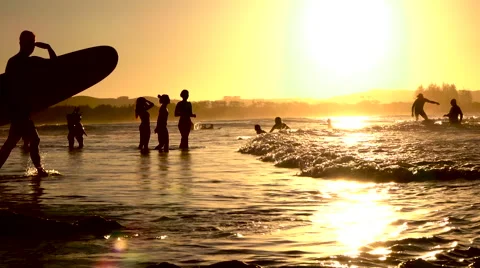 SLOW MOTION: Unrecognizable people spending summer vacation on beach at sunset Stock Footage 64739944