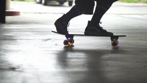 Slow motion Unrecognizable Skateboarder with light up wheels Medium shot Stock Footage 105262425