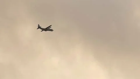 Slow motion: US Air Force (USAF) military plane flying in a cloudy sky in autumn Stock Footage 143606777