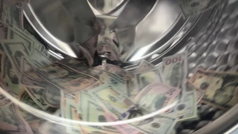Slow motion of US dollar banknotes inside spinning washing machine drum Stock Footage 340141464