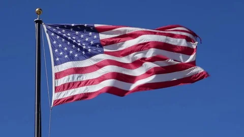 SLOW MOTION US FLAG OVER BLUE SKY Video stock 95825493