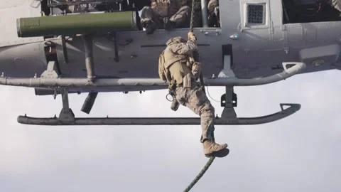 Slow motion U.S. Navy sailor fastroping onto USS Boxer LHD 4 from MH-60 Sea Hawk Stock Footage 293060730