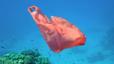 Slow motion, Used red plastic shopping bag slowly drifts underwater, on Stock Footage 147869680