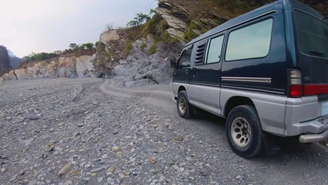Slow motion of a van jeep four wheels drive vehicle car passing through riding a Stock Footage 265493394