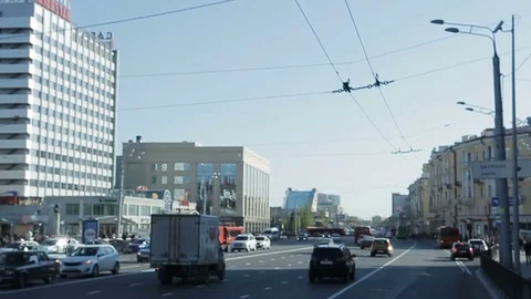 Slow Motion Vehicles Drive along Road Past City Hotel Stock Footage