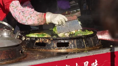Slow motion of vendor adding oysters to pan at Taichung market Stock Footage 311816865