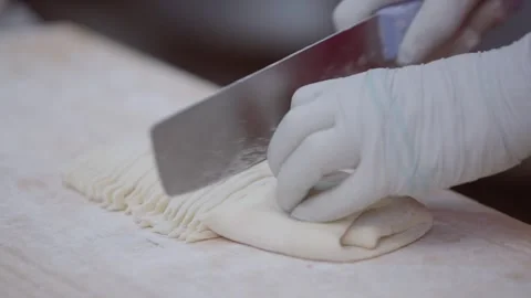 Slow motion of vendor cutting noodle dough with large knife Stock Footage 314126877