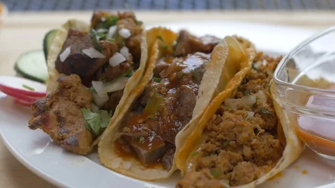 Slow Motion Verde Salsa Drizzling on Delicious Tacos and Mexican Dinner Stock Footage 113661886