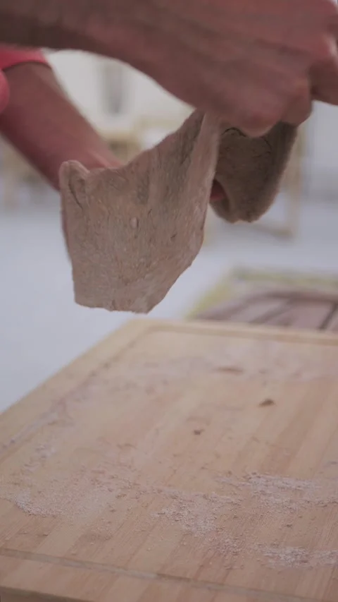 Slow motion vertical hands stretching pizza dough, homemade, Italy Видео 336920842