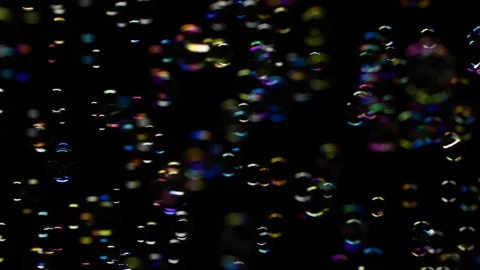Slow motion of vertical soap water bubbles texture flying over black background Stockbeeldmateriaal 188653166