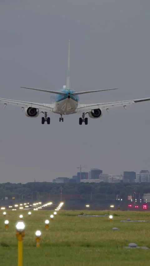 Slow motion vertical video of airplane landing at airport Stock Footage 300637619