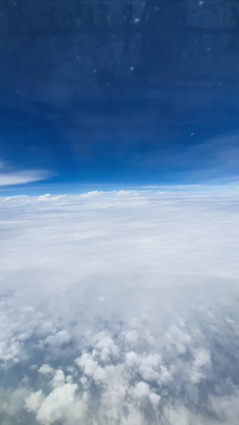 Slow motion vertical video view from airplane window above soft white clouds und Stock Footage 331888172