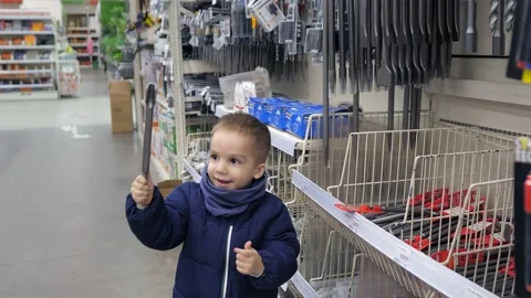 Slow motion video of the 3 years old caucasian boy playing with a building tool Stock Footage 232218916