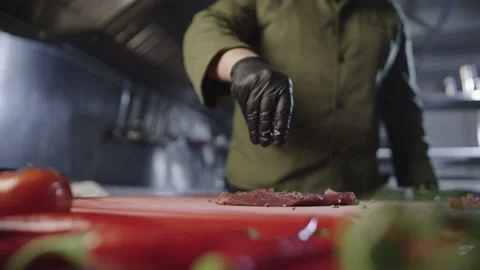 Slow motion video of adding ingredients and spices to steak. Stock Footage 231053165