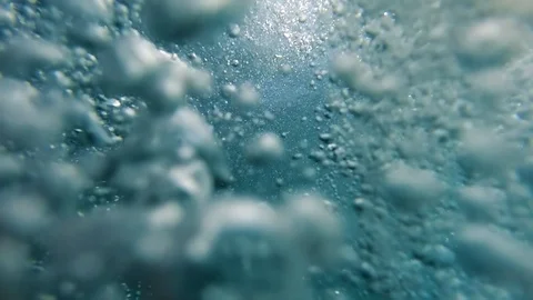 Slow motion video of air bubbles floating and lifting up to the ocean water Stock Footage 124939641