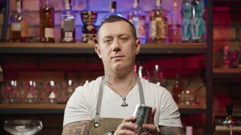 Slow motion video of a bartender throwing a shaker and mixing a cocktail. Stock Footage 231910254