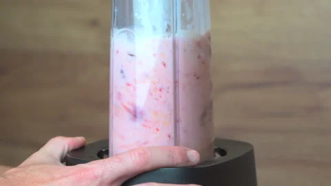 Slow motion video of blender mixing milk, ice and fruits for smoothie Stock Footage 204848725
