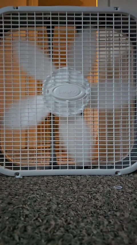 Slow motion video of a box fan blades spinning around 動画素材 277969768