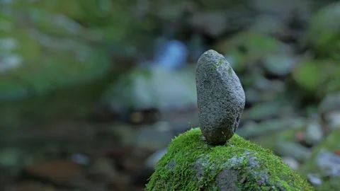 A slow-motion video capturing a small waterfall in a mountain stream Stock Footage 324560126