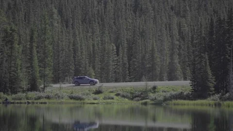 Slow Motion Video of a car driving down a mountain road Stock Footage 148000643