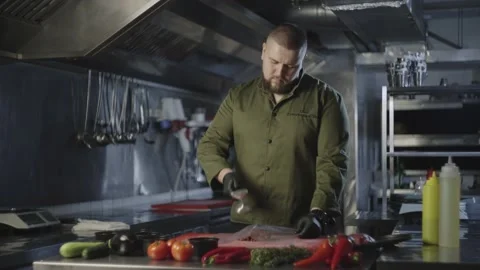 Slow motion video of a chef beating raw meat in the kitchen. Stock Footage 232373510