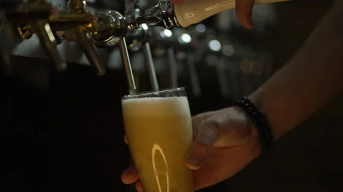 Slow motion video close up of pouring beer into a glass Stock Footage 154321836