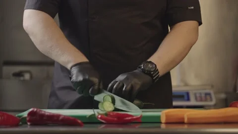 Slow motion video close-up of slicing a cucumber on a cutting board. Stock Footage 230646769