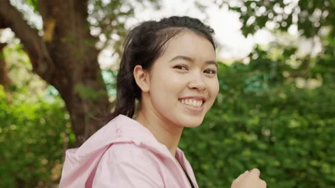 Slow motion video, close-up of a young Asian woman running and smiling happily. Stock Footage 145202705