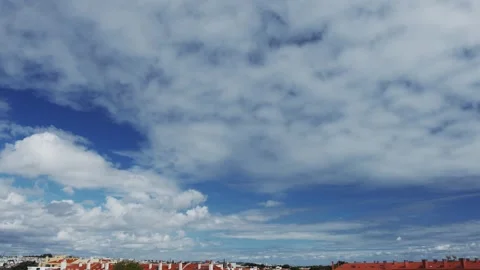 Slow motion video of cloudscape over city rooftops. Stock Footage 330108935