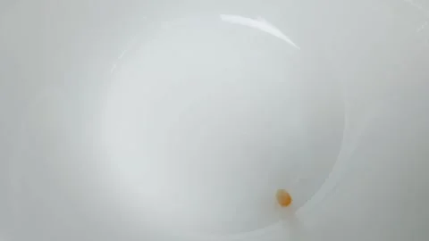 Slow motion video of corn kernels dropping into a white ceramic bowl. Stock Footage 160164614