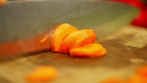 Slow motion video of cutting orange ripe carrots into rings. Stock Footage 296363630