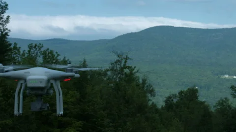 A slow motion video of a drone or quadcopter hovering and taking off in a Stock Footage 65497699
