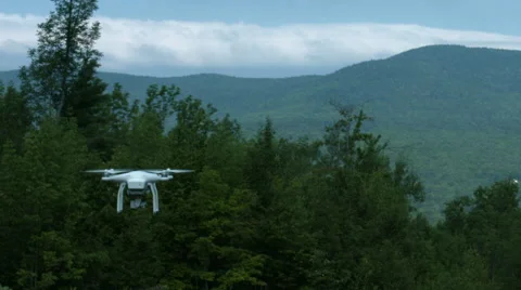 A slow motion video of a drone or quadcopter hovering and taking off in a Stock Footage 65497724