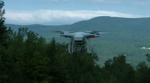 A slow motion video of a drone or quadcopter hovering and taking off in a Stock Footage 65497729