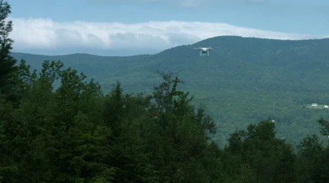 A slow motion video of a drone or quadcopter hovering and taking off in a Stock Footage 65497871
